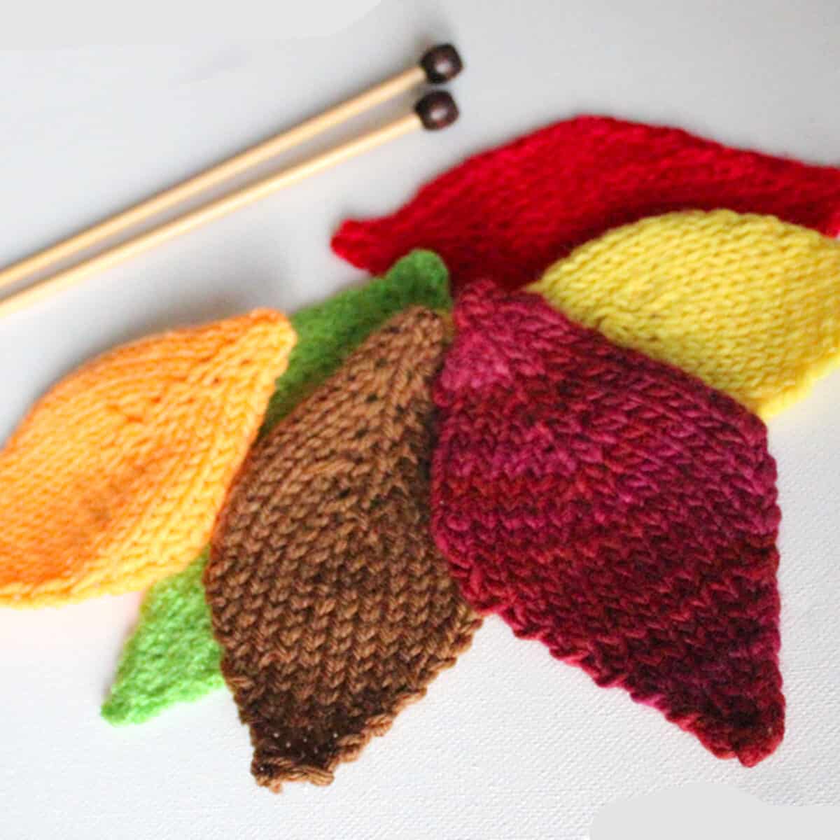 Knitted Leaf shapes in brown, green, yellow, and red colored yarn.