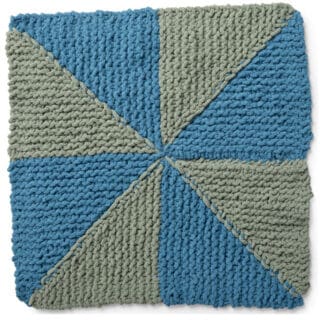 Knitted Square in the Pinwheel Design with blue and green yarn colors.