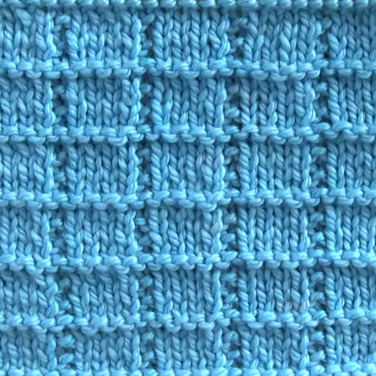 Knitted swatch in Tile Squares texture with blue colored yarn.