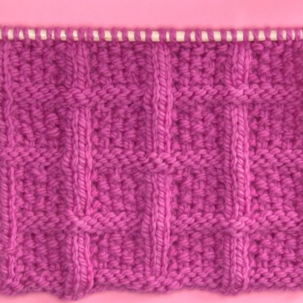 Lattice Seed Stitch Knitting Pattern in pink color yarn.