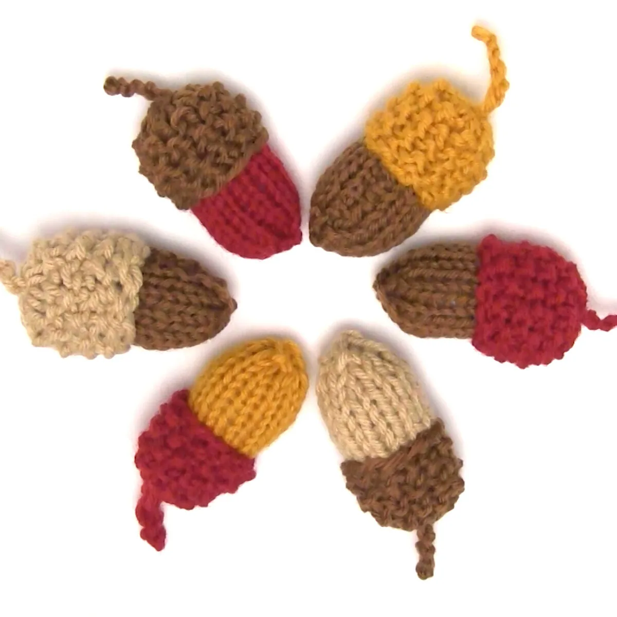 Group of knitted acorns arranged in a circle.