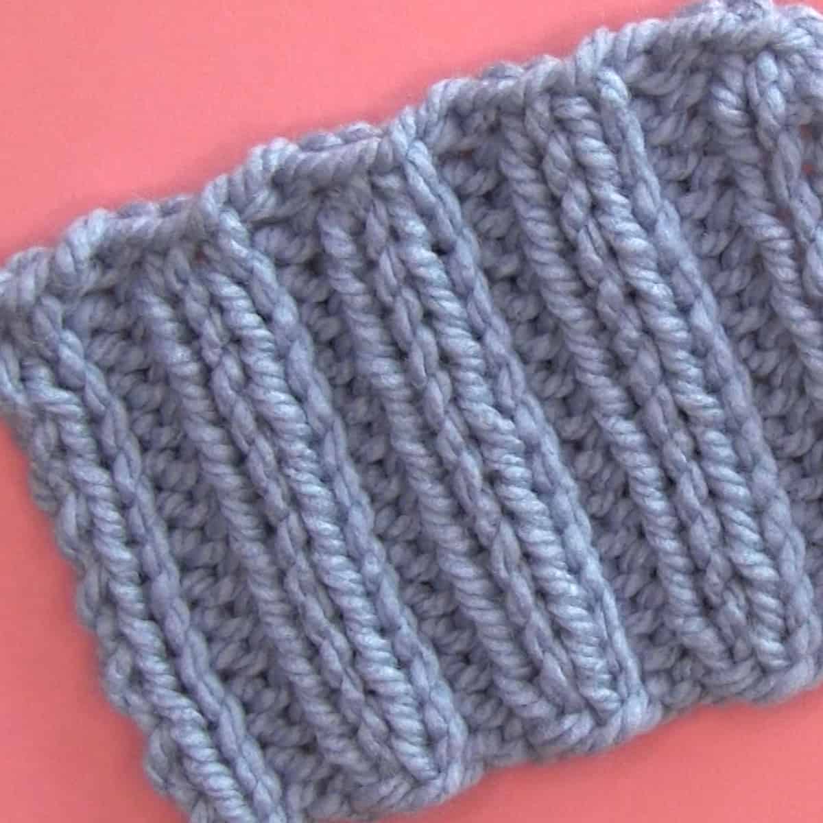 2x2 Rib knit stitch pattern cast off edge in pattern with knitwise and purlwise stitches.