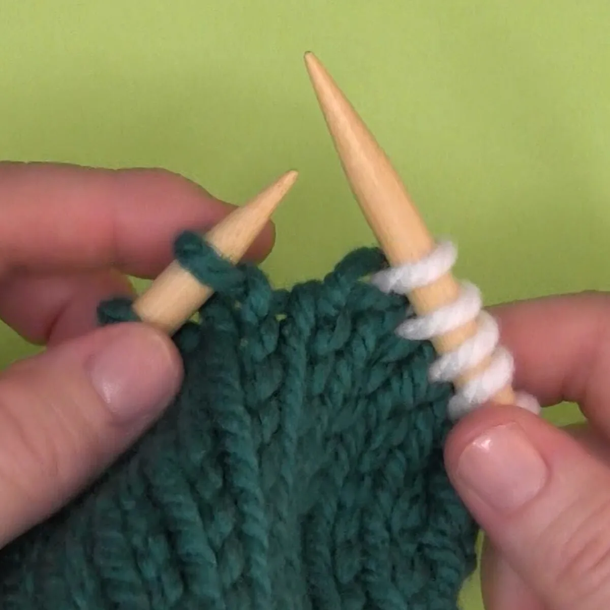 Right-handed demonstration of a finished twisted knit stitch.