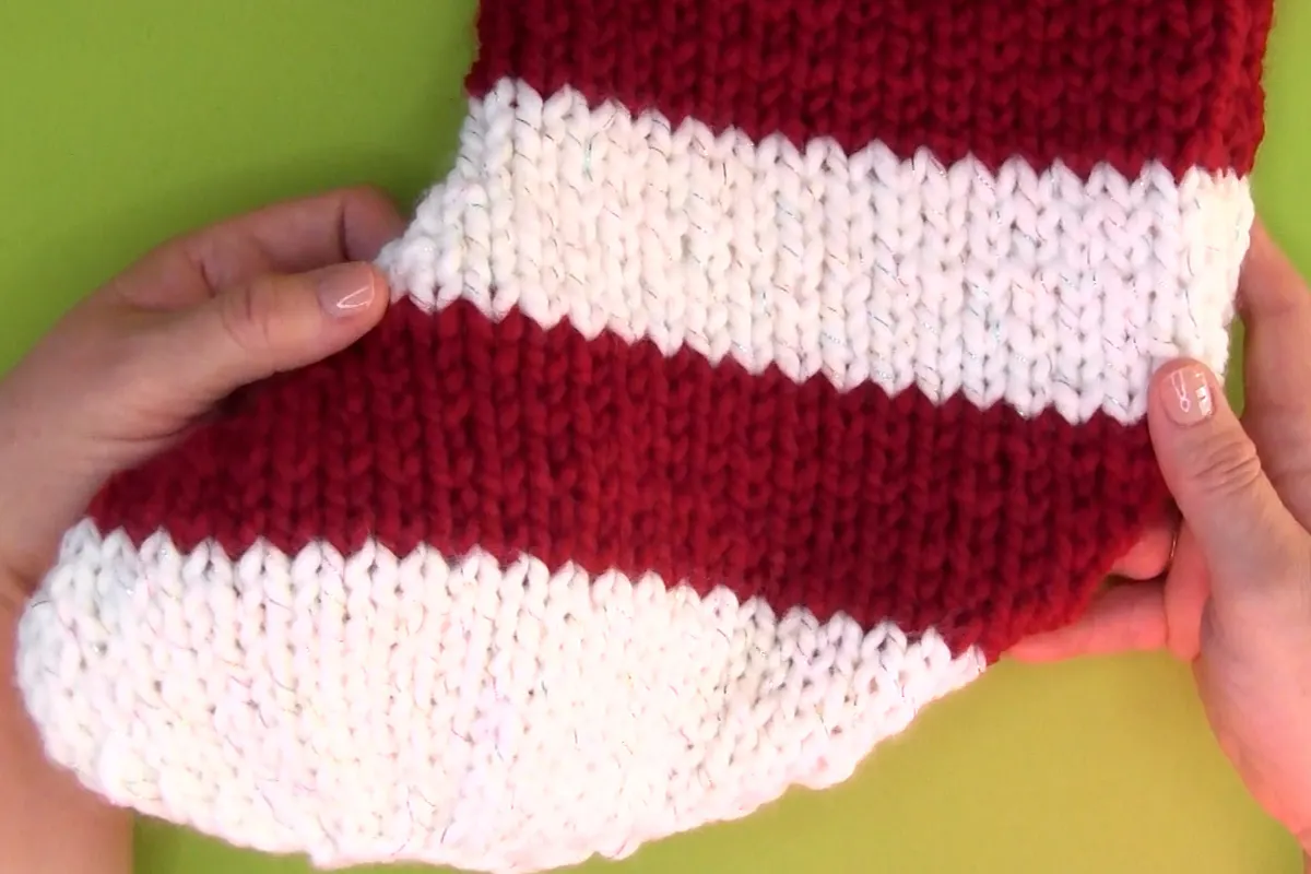 Christmas Stocking foot knitted in red and white yarn colors.