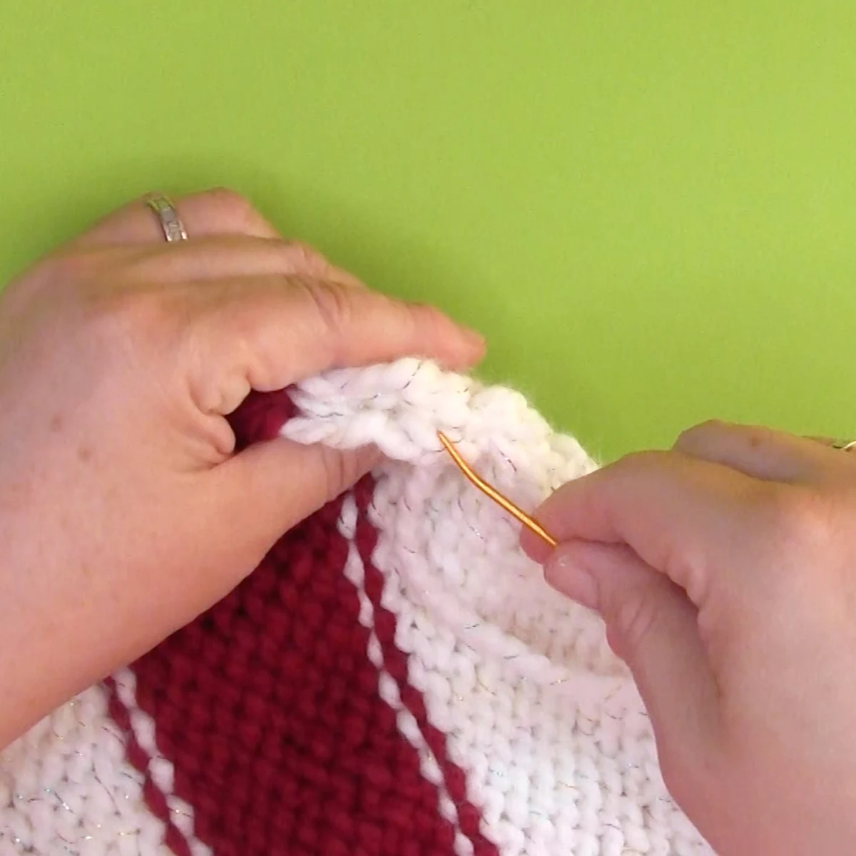 Seaming knitted Christmas Stocking with the mattress stitch sewing technique.