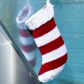 Knitted Christmas Stocking with red and white stripes.