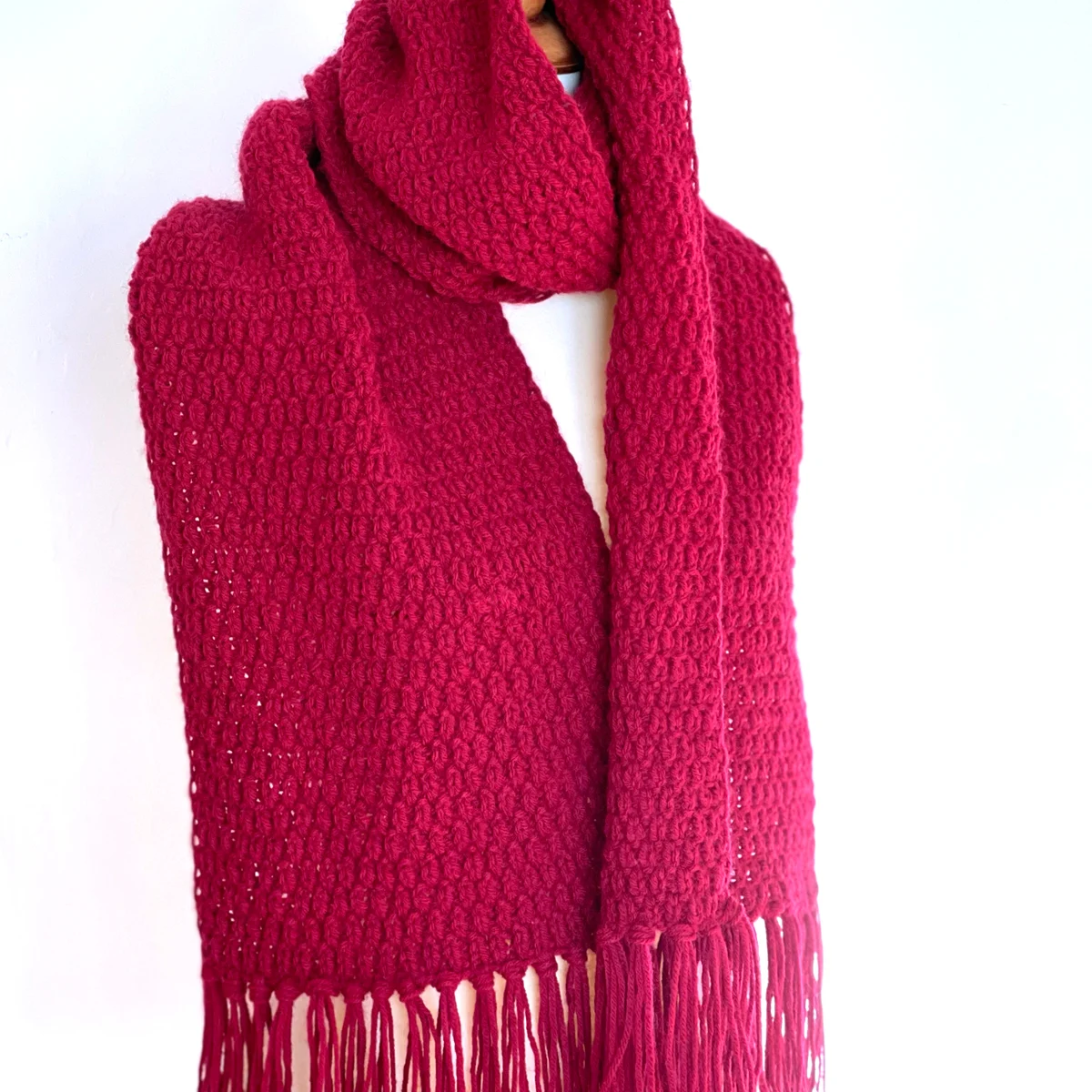 All Too Well Scarf in burgundy color yarn with fringe tassels by Studio Knit.