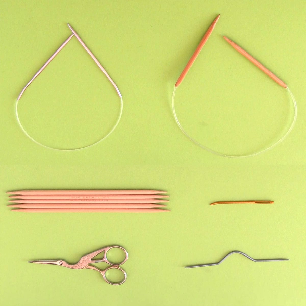 Knitting supplies with circular needles, double pointed needles, and cable needle.