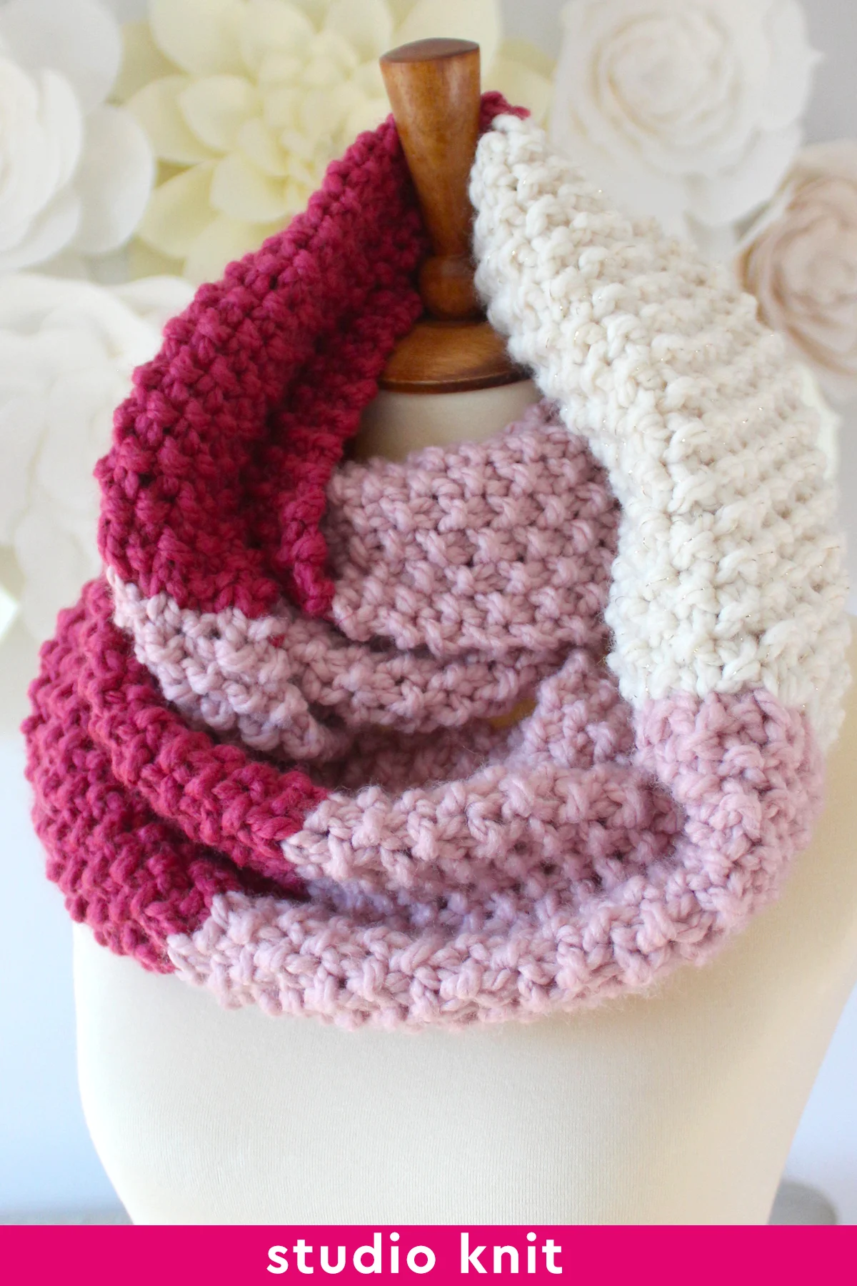 Seed Stitch Infinity Scarf in pink and red yarn colors with knitting pattern.