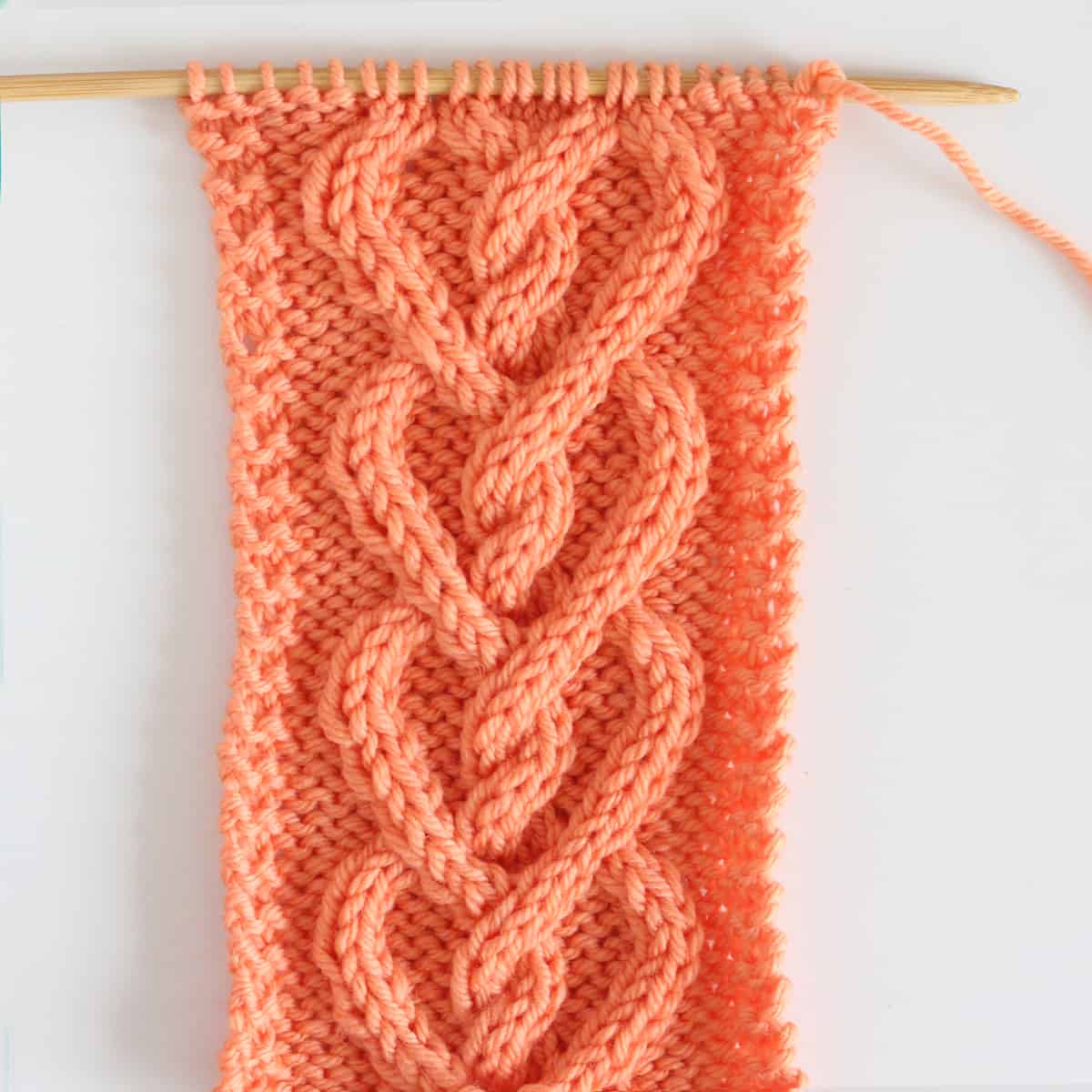 Cable Heart Stitch pattern on knitting needle.