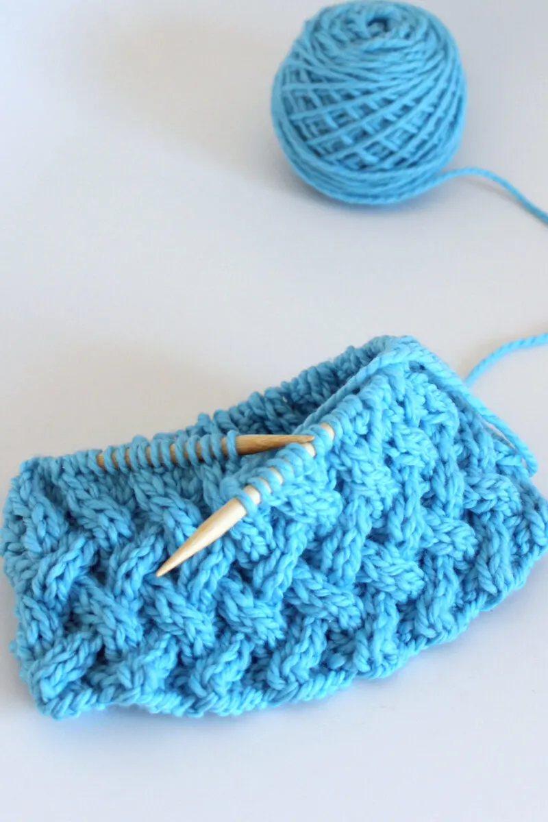 Lattice Cable stitch on circular needle with blue color yarn.