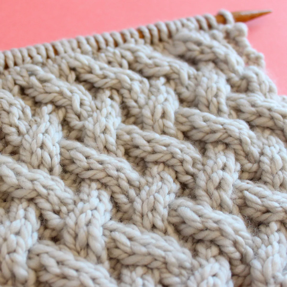 Close-Up texture of the Lattice Cable stitch pattern on knitting needle.