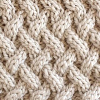 Lattice Cable Knit Stitch Pattern texture in beige color yarn.