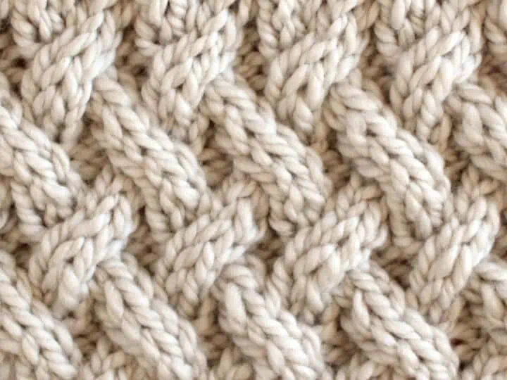Lattice Cable Knit Stitch Pattern texture in beige color yarn.