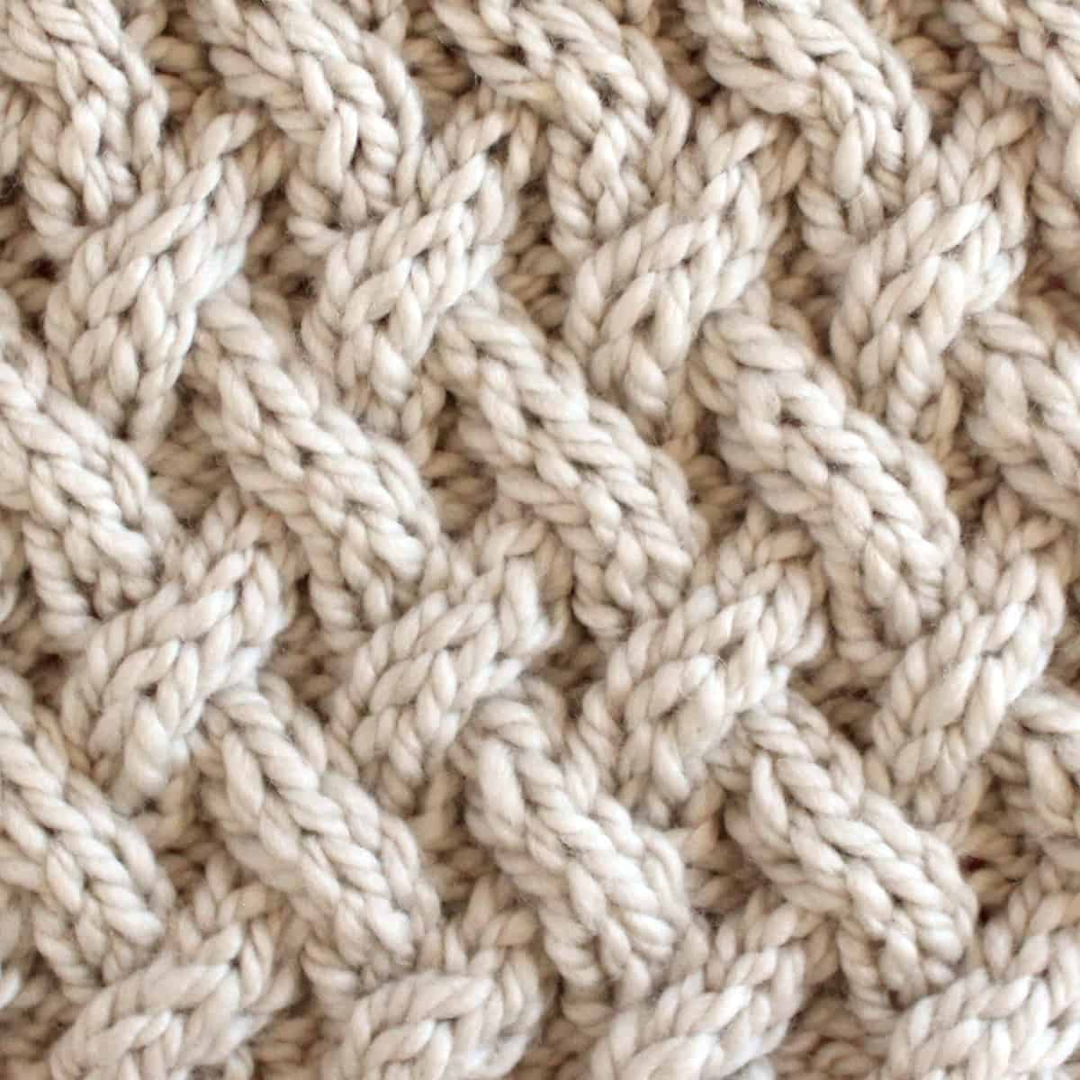 Lattice Cable Knit Stitch Pattern texture in beige color yarn.