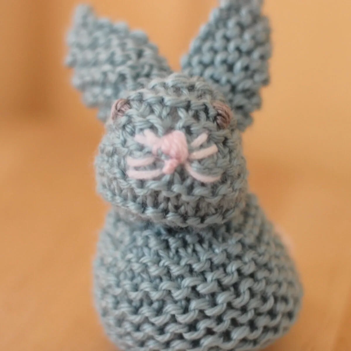 Front face of the knitted bunny from a square.