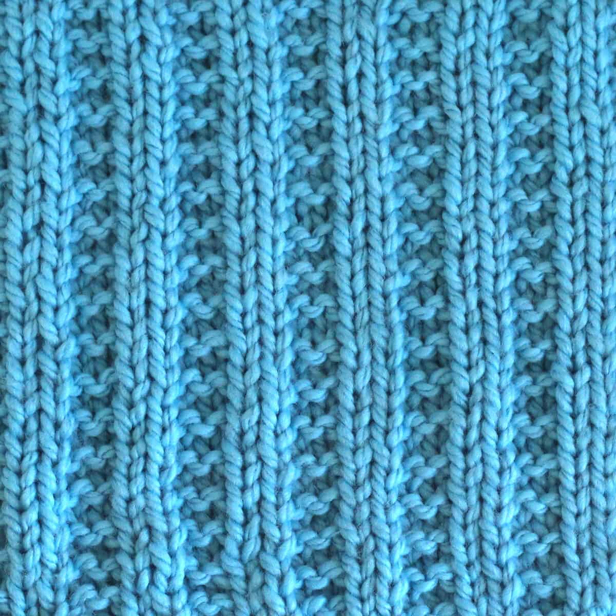 Garter Ribbing knit stitch texture in blue color yarn.