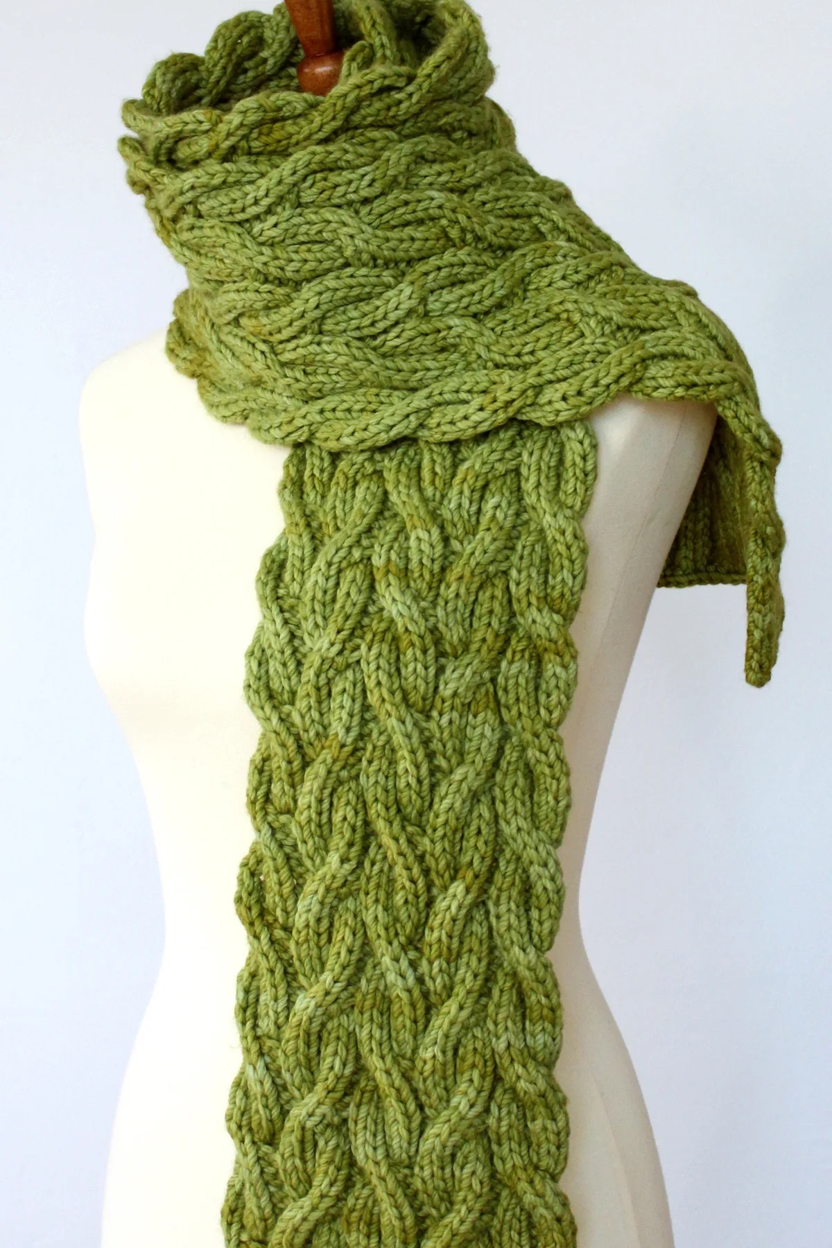 Reversible Cable Scarf in green yarn designed by Studio Knit.