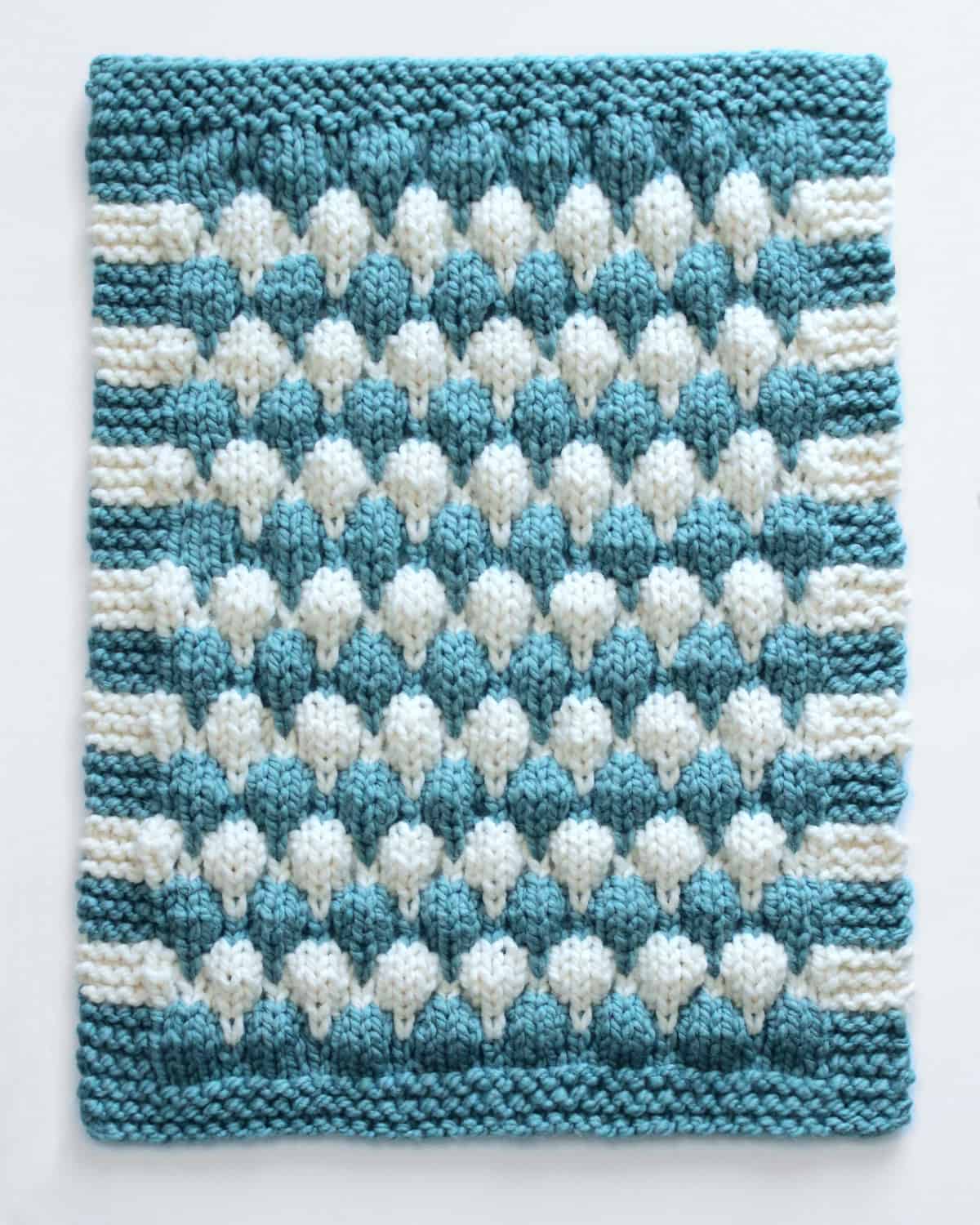 Knitted Chunky Blanket in Baby Stroller size with blue and white yarn colors.