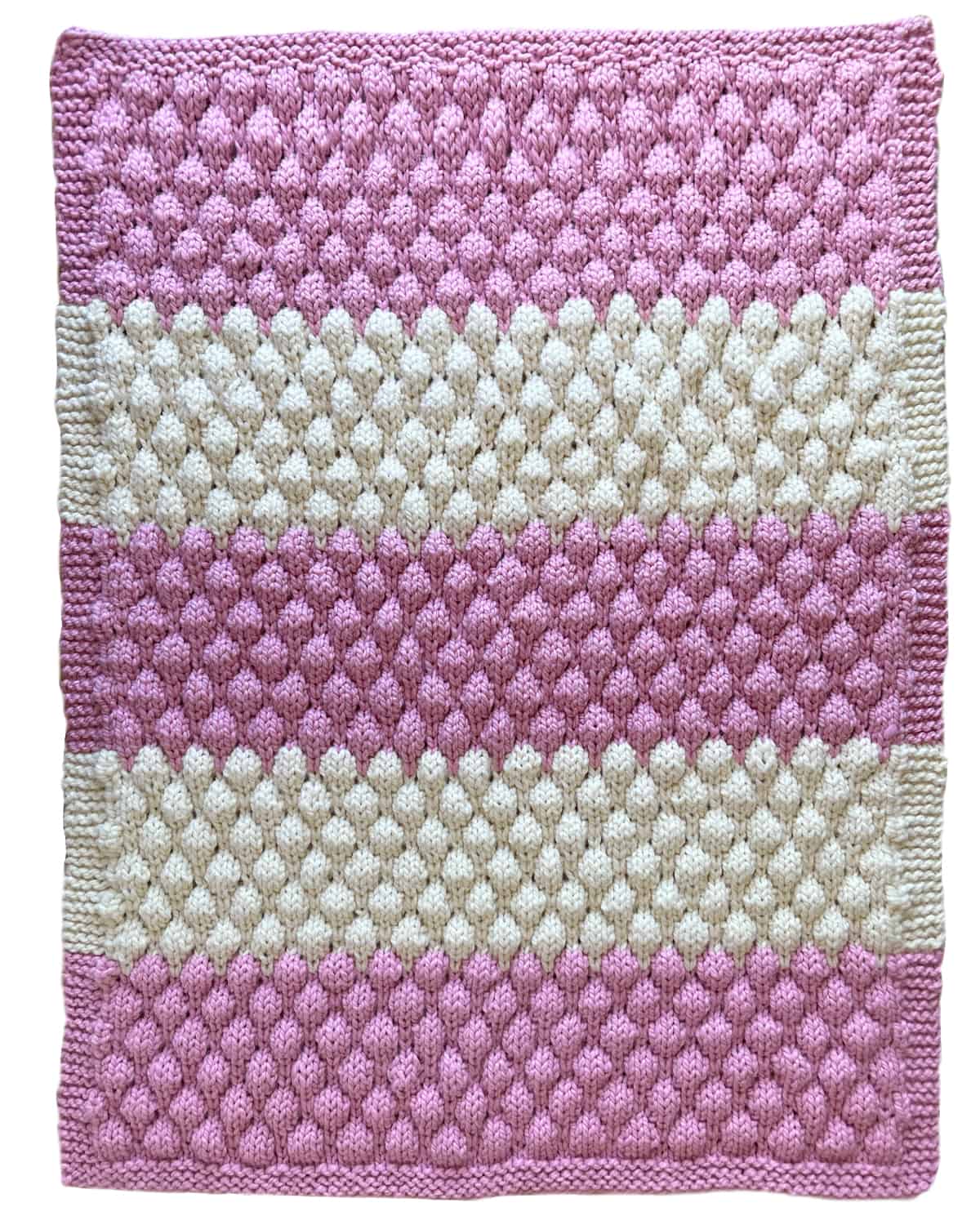 Afghan Blanket knitted in Bubble Stitch with pink and cream color yarn.