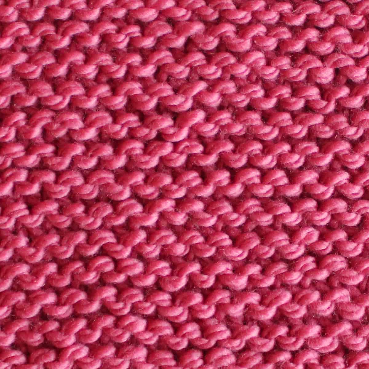 Garter stitch knitted in pink color yarn.