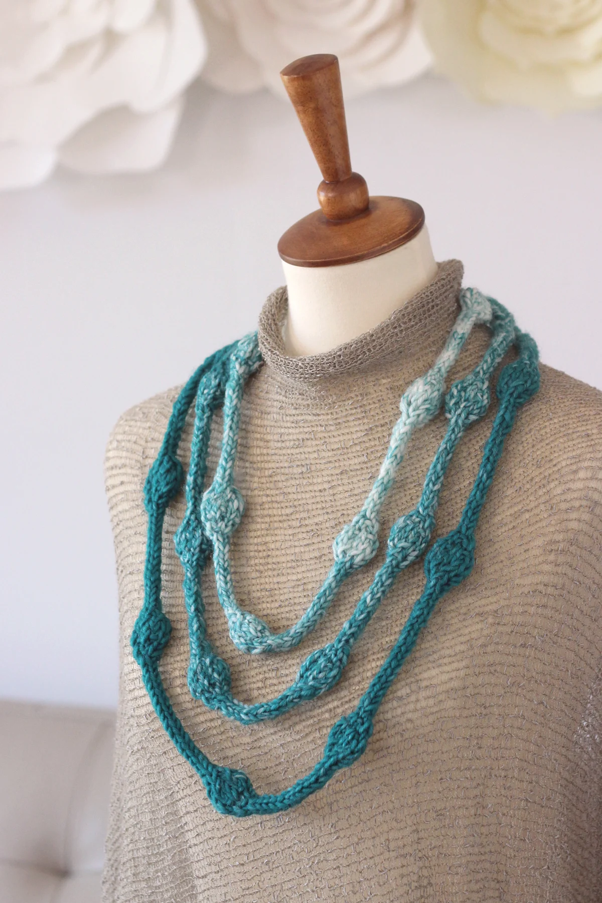 Knitted Necklace with Beaded Texture in blue and white yarn colors displayed on a mannequin.