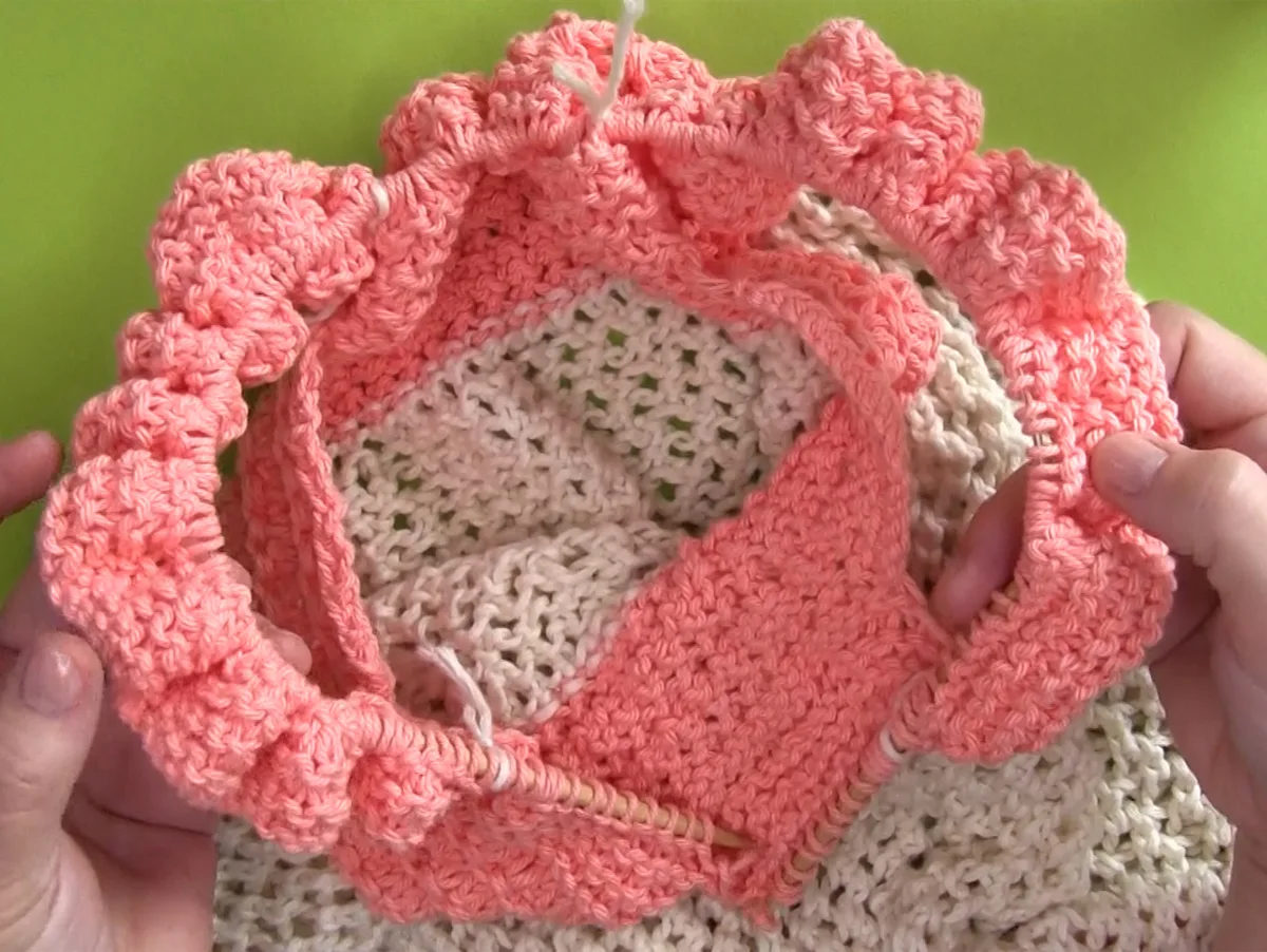 Knitting handles of market bag onto a circular needle.