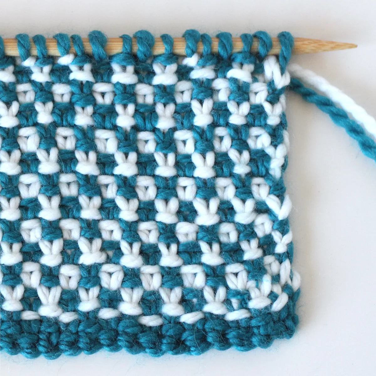 Linen Stitch knitted flat with blue and white yarn colors.