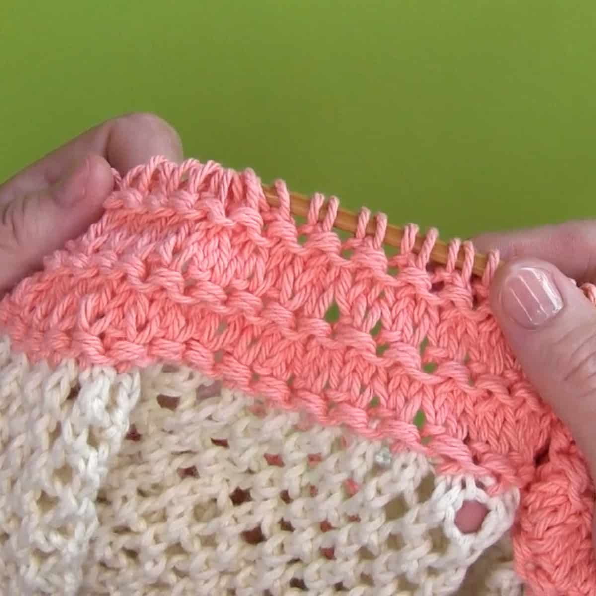 Knitting the top of a mesh bag in granite stitch.