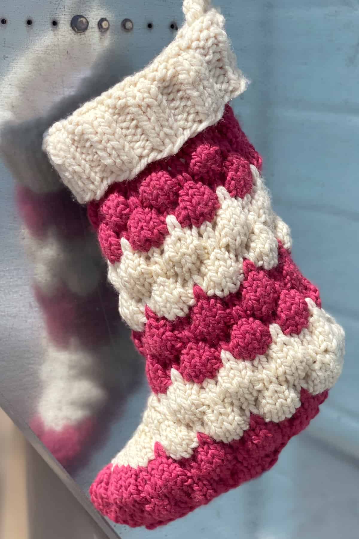 Red and white knitted Christmas Stocking in bubble stitch.