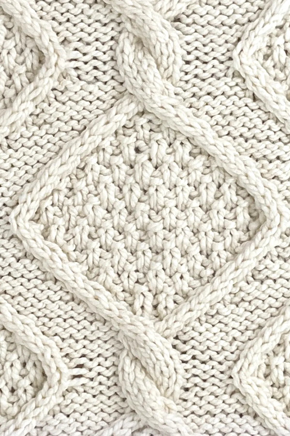 Diamond cable with double moss stitch pattern inside with rope twists atop a reverse stockinette background.