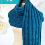 Knitted Pennant Pleating Stitch scarf designed by Studio Knit in blue color yarn.