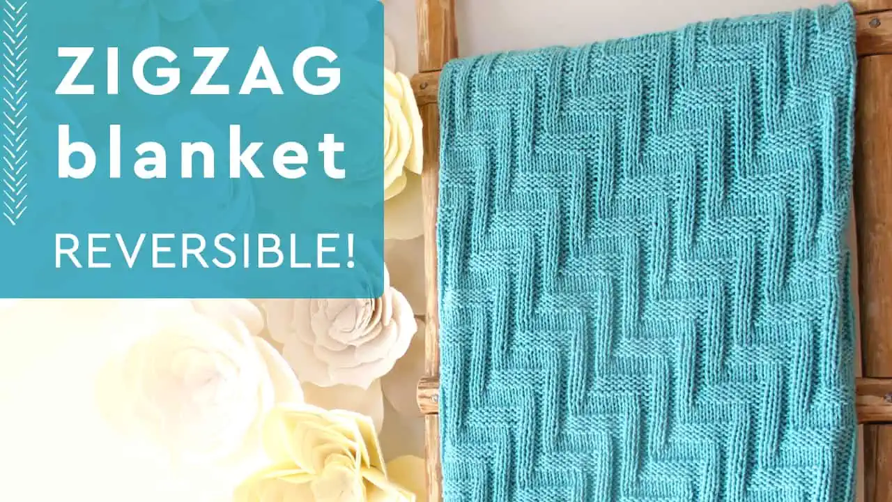 Knitted Blanket in zigzag stitch texture on wooden ladder in blue yarn color.