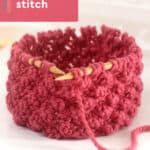 Raspberry knit stitch on circular bamboo needles with dark pink colored yarn.