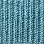 Fisherman's Rib knit stitch pattern knitted flat in light blue yarn color.