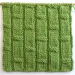 Bamboo Ribbing texture knitted in green colored yarn on bamboo needle.