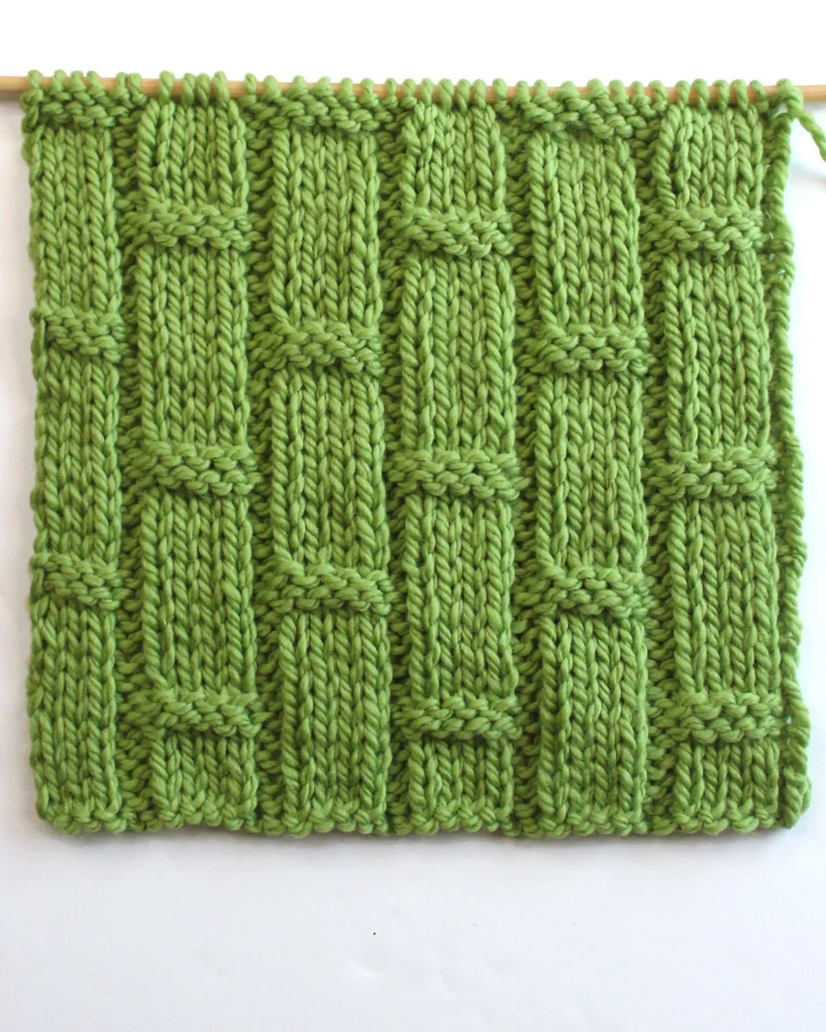 Bamboo Ribbing texture knitted on bamboo needle with green colored yarn.