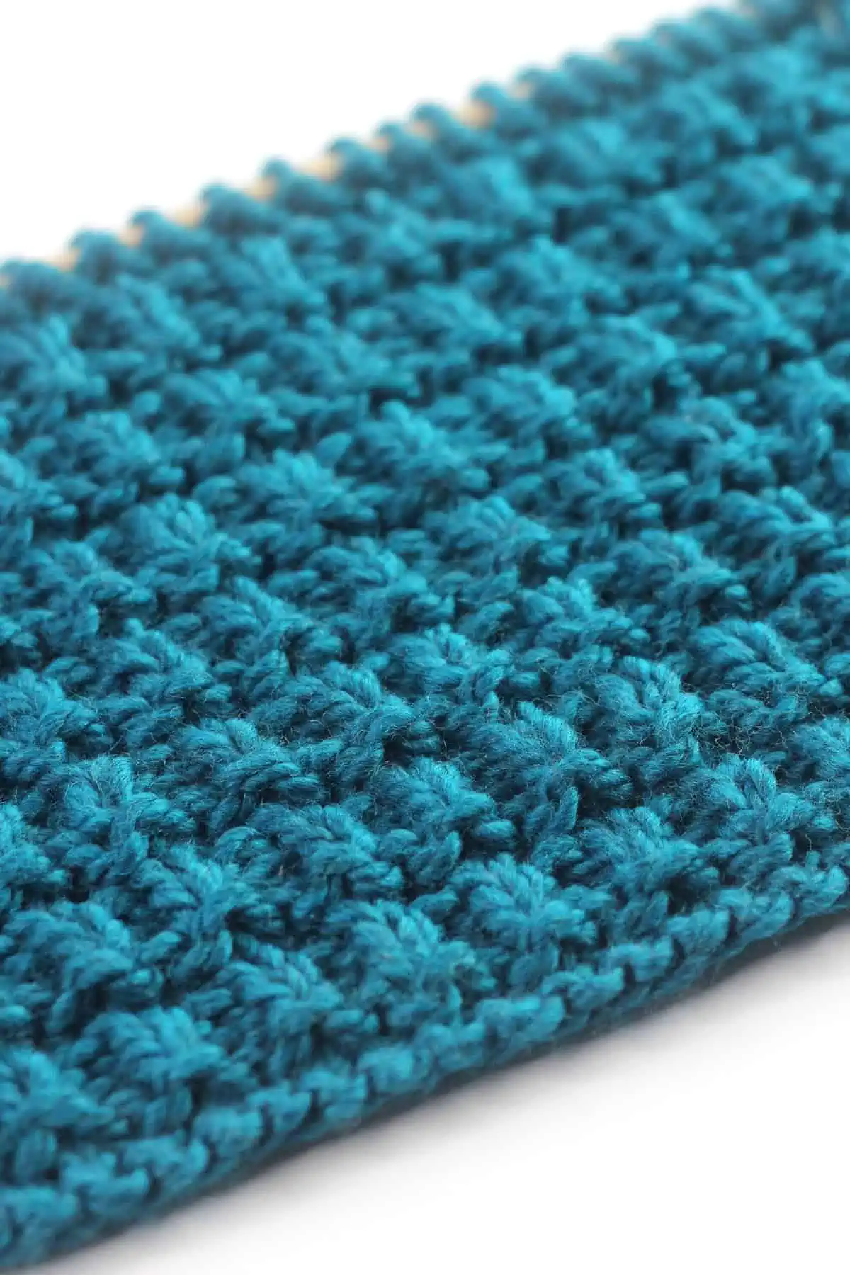 Close-up of Hurdle stitch texture knitted with blue colored yarn.