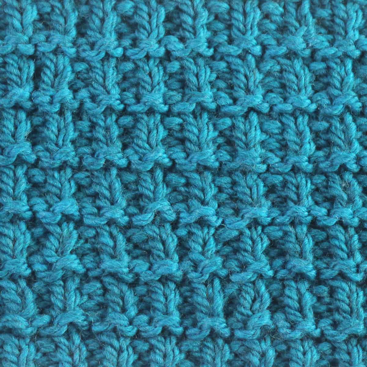 Hurdle stitch texture knitted with blue colored yarn.