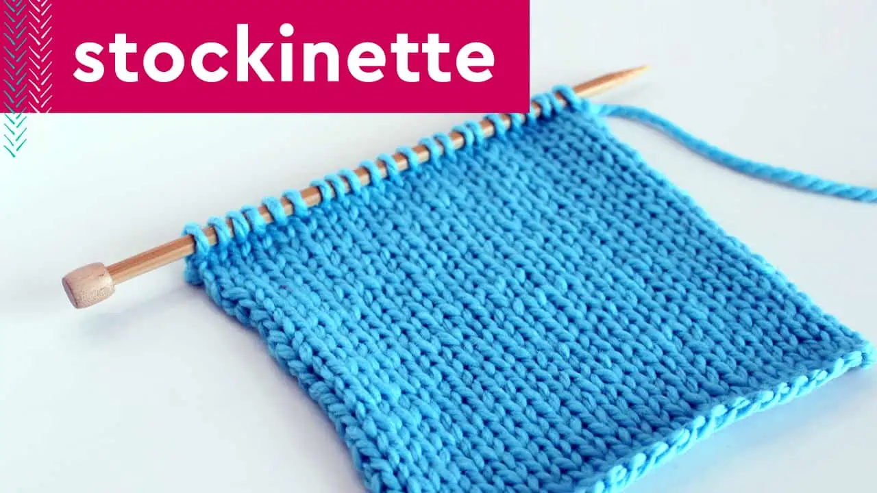 Stockinette Stitch in blue colored yarn on wooden knitting needle.