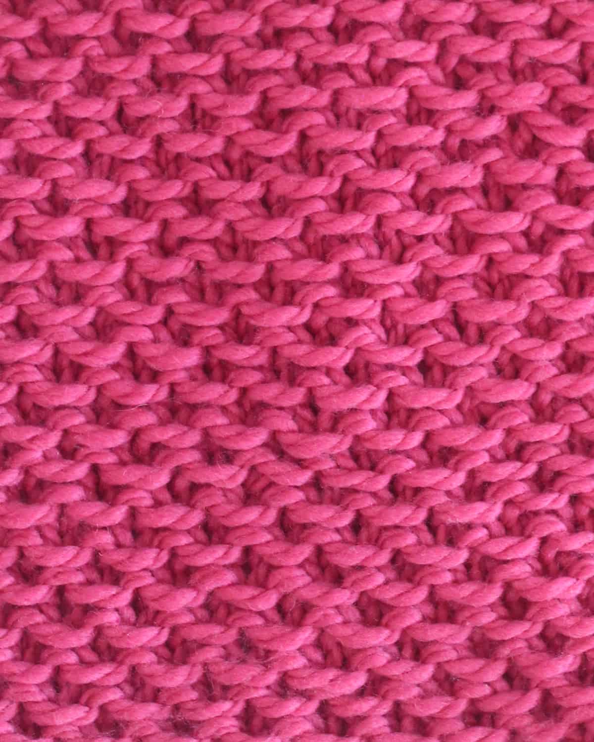 Stamen stitch knitting texture in pink yarn color.