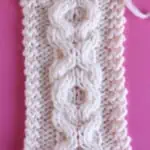XO Cable textured pattern knitted on straight needles with white colored yarn.