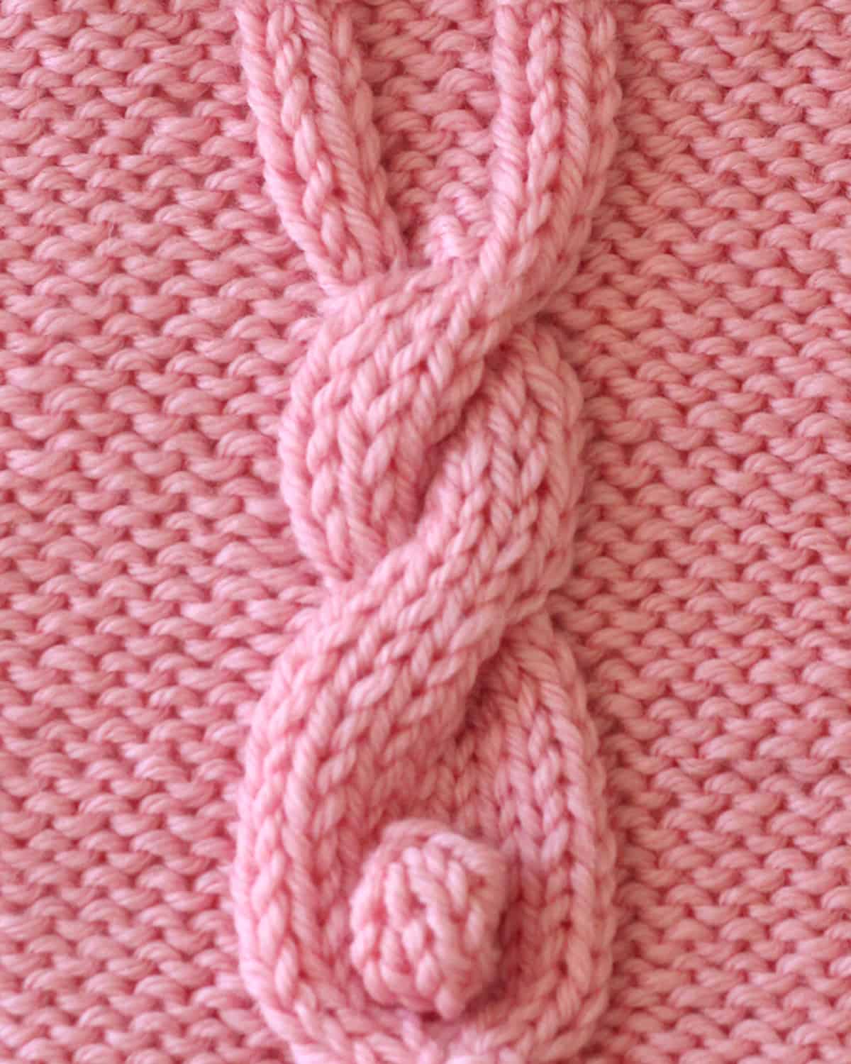 Bunny Cable knitting square in pink yarn color.