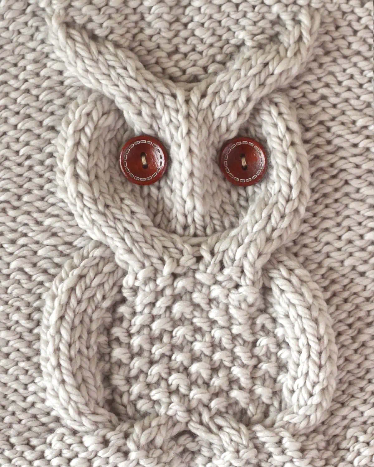 Owl Cable Stitch Square in beige yarn color with brown button eyes.