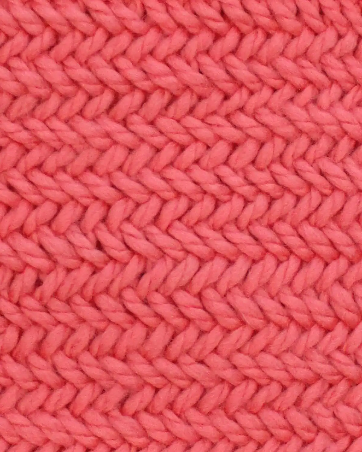 Horizontal Herringbone knit stitch pattern in orange colored yarn.