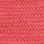 Horizontal Herringbone stitch knitting pattern by Studio Knit in orange-colored yarn.