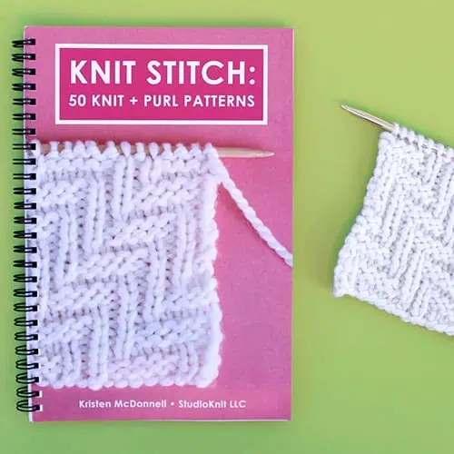 Knit Stitch Pattern Book with Lay Flat Wire-O Binding and Knitted Swatch on Green Background.