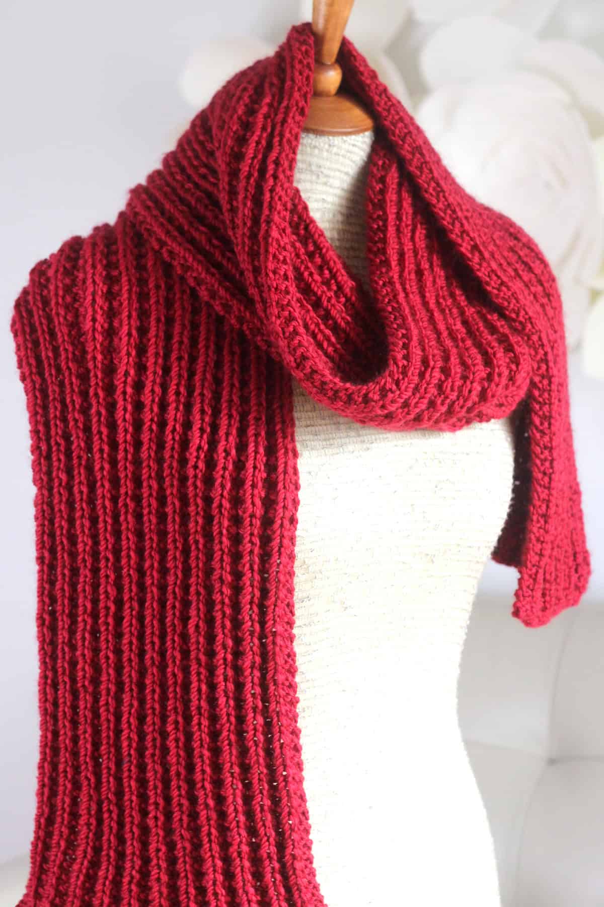Hot Frosty Scarf designed with Seeded Rib Stitch knitted in red colored yarn.