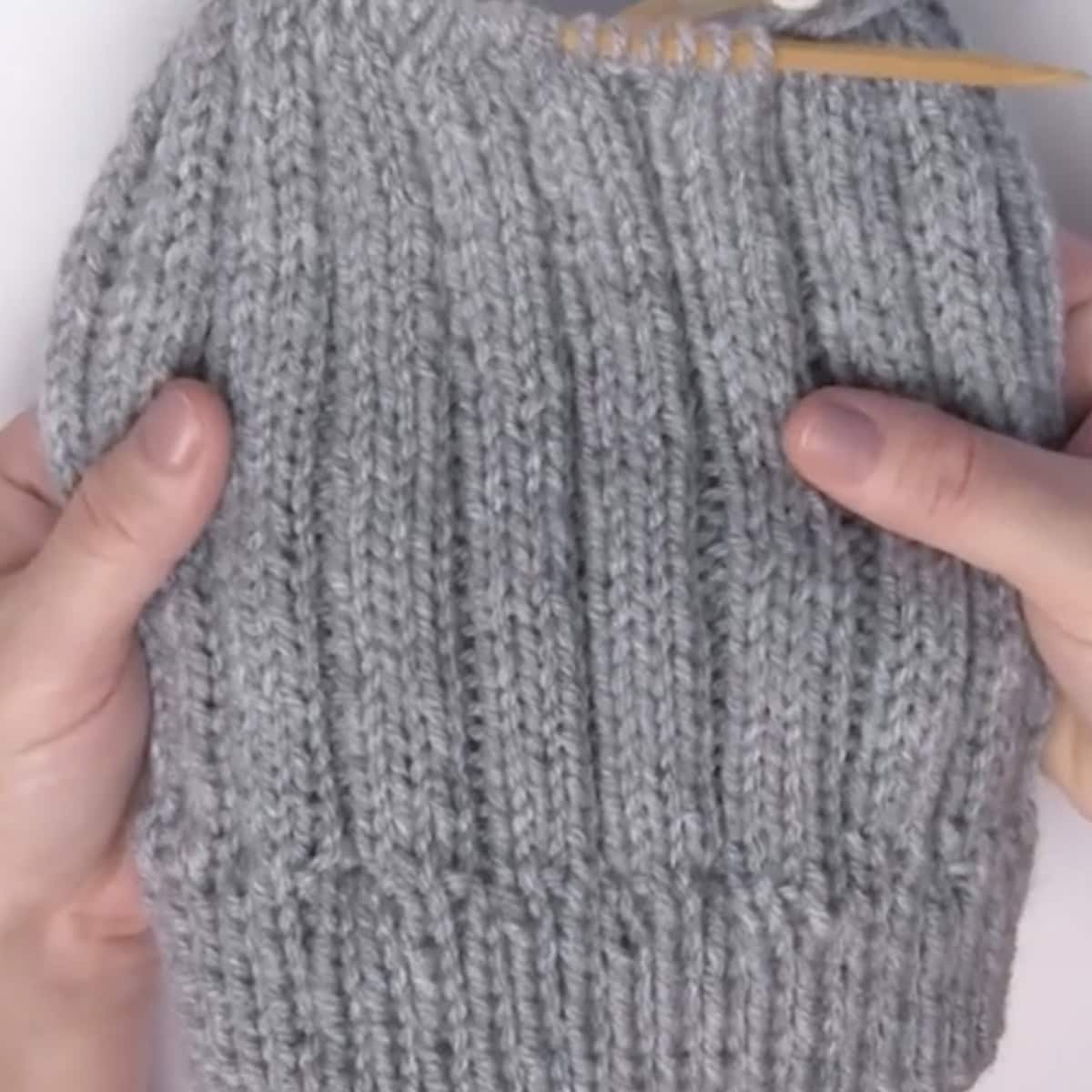 Body of ribbed knitted hat.