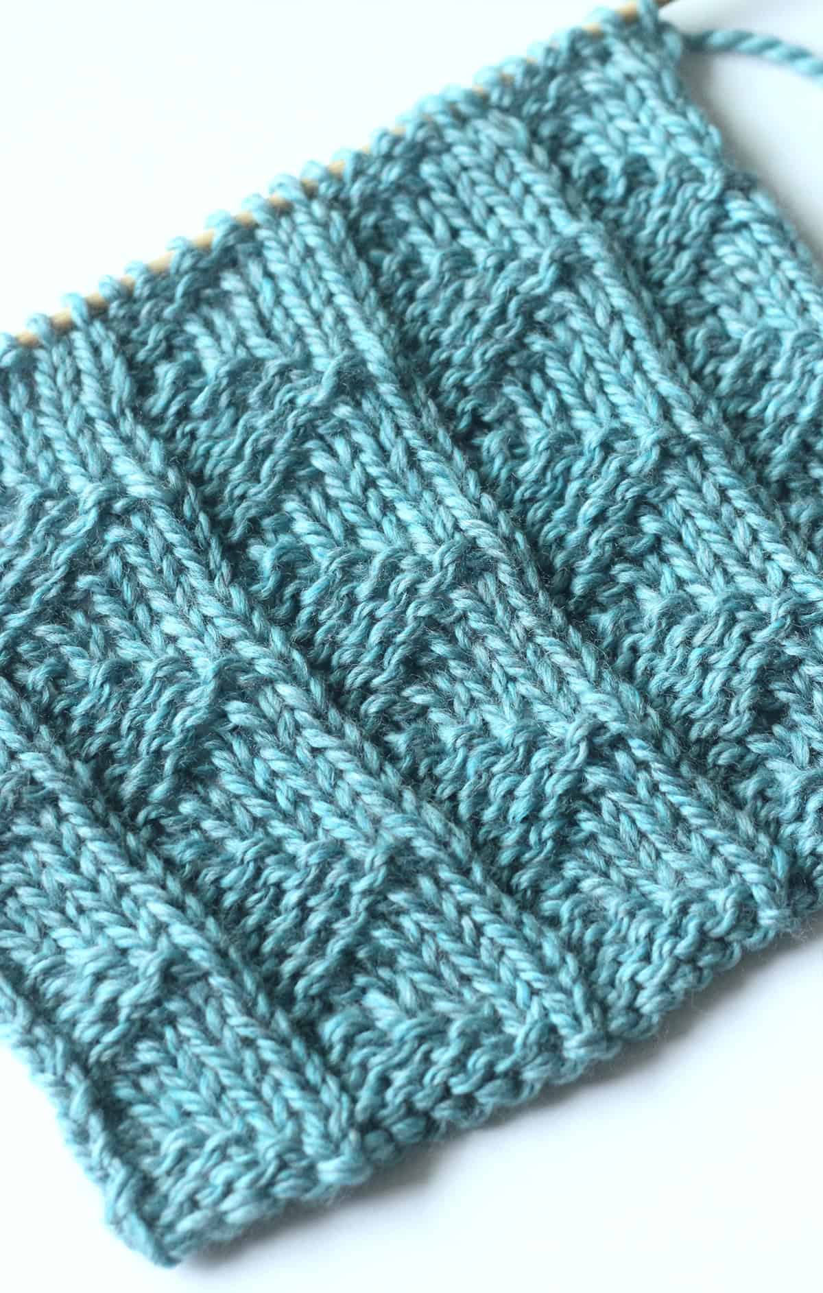 Pennant Pleating knit stitch pattern in blue yarn color.